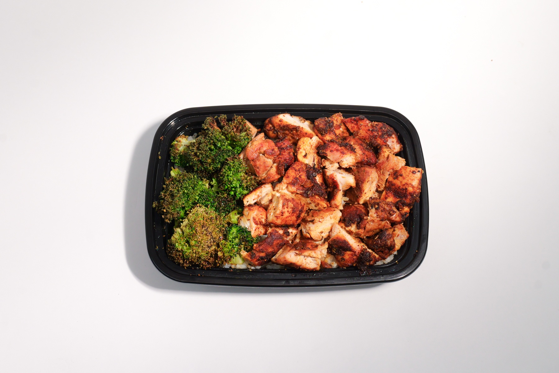 Big Chicken meal prep boxes with rice and broccoli